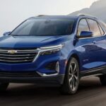 A blue 2022 Chevy Equinox is shown driving after visiting a used Chevy Equinox dealer.