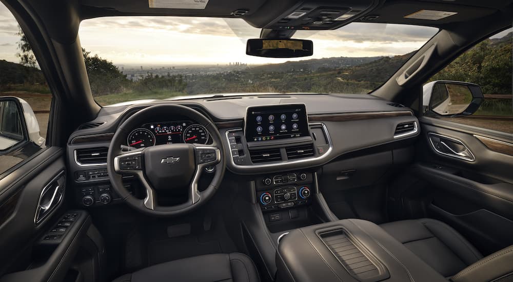 The black interior of a 2023 Chevy Tahoe is shown from the drivers seat.