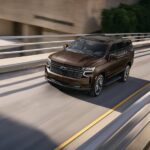 A brown 2022 Chevy Tahoe RST is shown from the front at an angle.