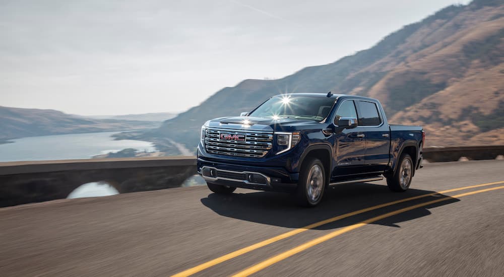 A black 2022 GMC Sierra 1500 Denali is shown from the front at an angle after leaving a Chevy dealer.