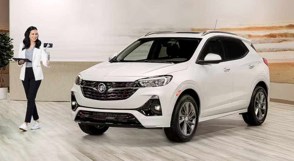 A white 2023 Buick Encore GX is shown on a showroom floor.