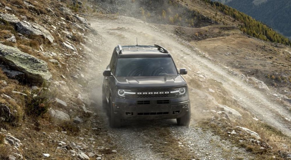 A black 2023 Ford Bronco Sport Badlands Edition is shown driving off-road.