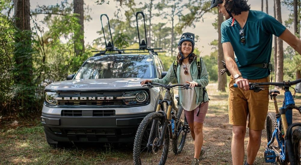 A white 2023 Ford Bronco Outer Banks Edition is shown parked off-road after competing in a 2023 Buick Encore GX vs 2023 Ford Bronco Sport comparison.