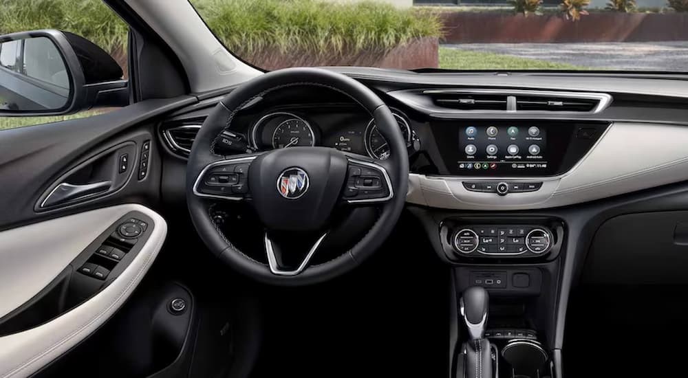 The black and white interior and dash of a 2023 Buick Encore GX is shown.