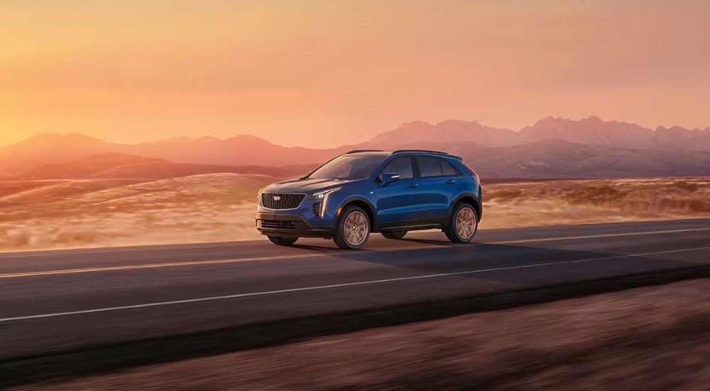 A blue 2023 Cadillac XT4 is shown driving after winning a 2023 Cadillac XT4 vs 2023 Acura RDX comparison.