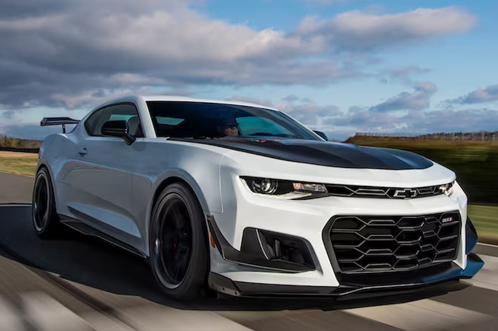 A white 2023 Chevy Camaro ZL1 1LE is shown driving on a road.
