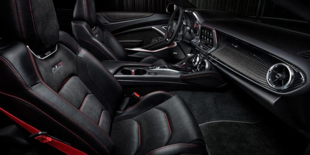 The black and red interior and dash of a 2023 Chevy Camaro ZL1 is shown.