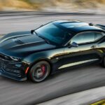 A black 2023 Chevy Camaro ZL1 is shown driving on a track.