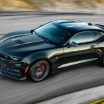 A black 2023 Chevy Camaro ZL1 is shown driving on a track.