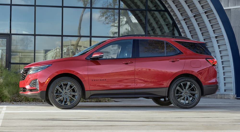 A red 2023 Chevy Equinox is shown parked on a street.