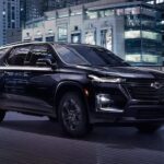 A black 2023 Chevy Traverse Midnight Edition is shown driving on a bridge