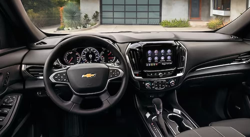 The black interior and dash of a 2023 Chevy Traverse is shown.