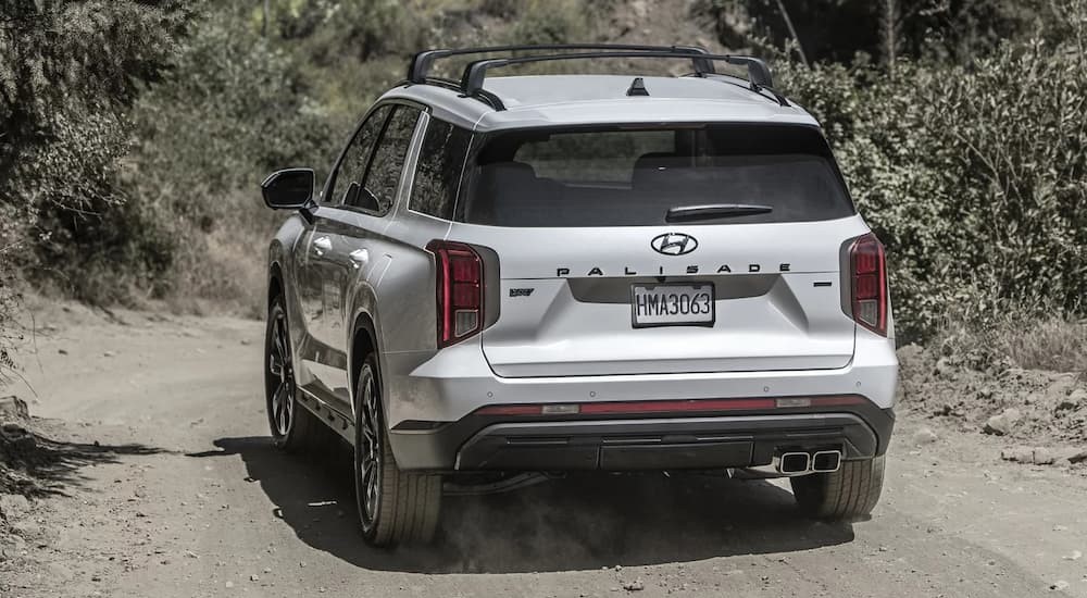 A white 2023 Hyundai Palisade is shown from the rear.