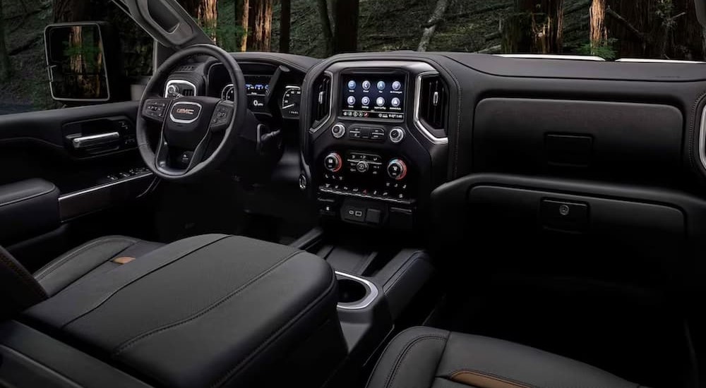 The black interior and dash of a 2023 GMC Sierra 2500 HD AT4 is shown.
