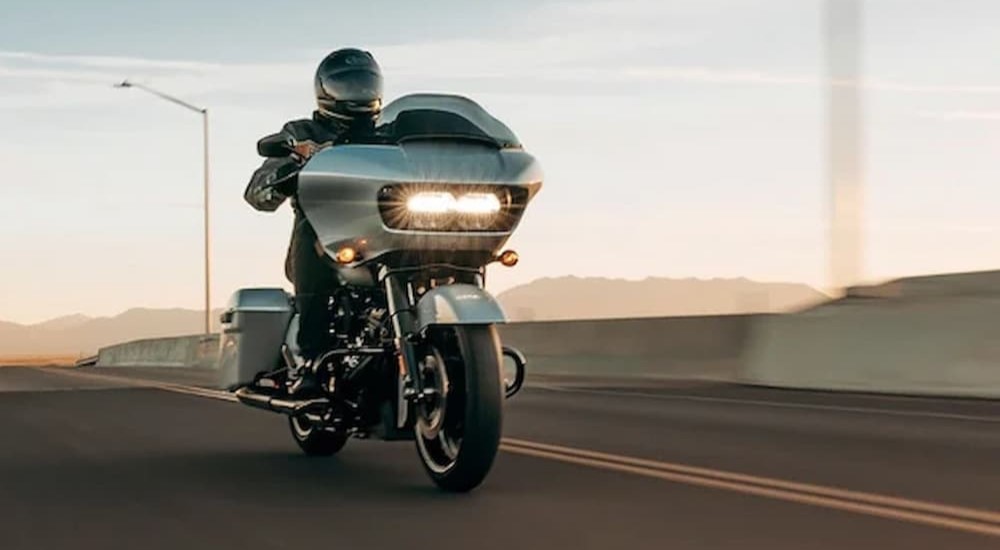 A 2023 Harley-Davidson Road Glide Special is shown driving on a highway.