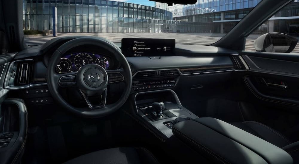 The black interior and dash of a 2024 Mazda CX-90 PHEV is shown.