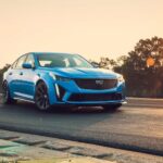 A 2023 Cadillac CT5 V Blackwing is shown driving on a road.