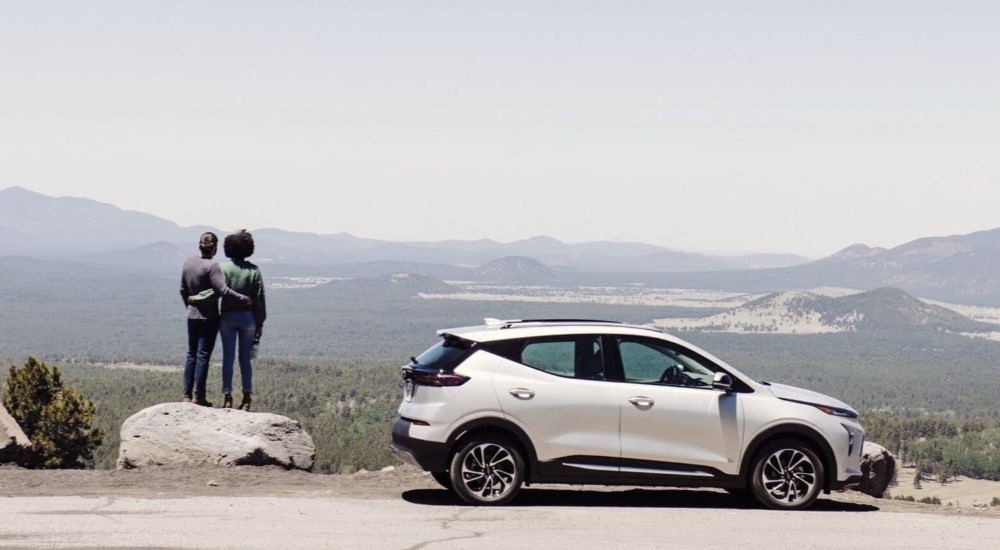 A white 2023 Chevy Bolt EUV is shown parked near the mountains.