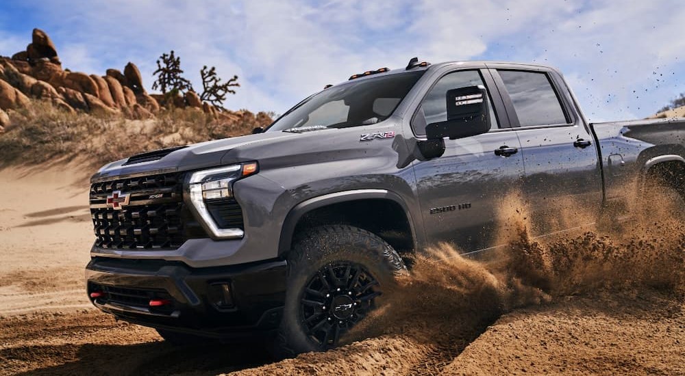 A gray 2024 Chevy Silverado 2500 HD ZR2 is shown off-roading.