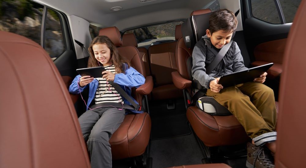 Kids are shown using tablets in a 2018 Chevy Traverse.
