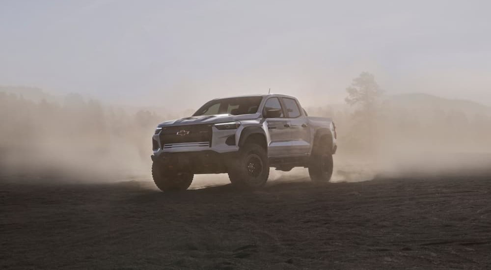 A white 2024 Chevy Colorado ZR2 Bison is shown parked off-road.