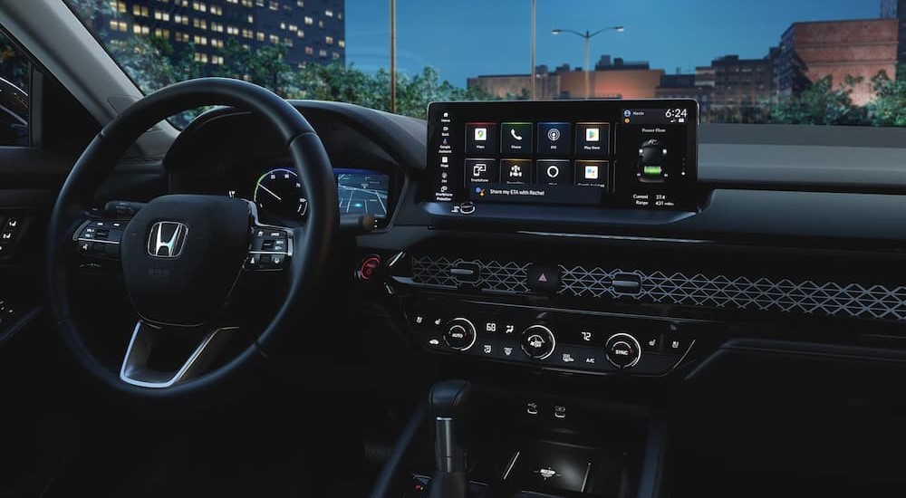 The black interior and dash of a 2023 Honda Accord Hybrid is shown.