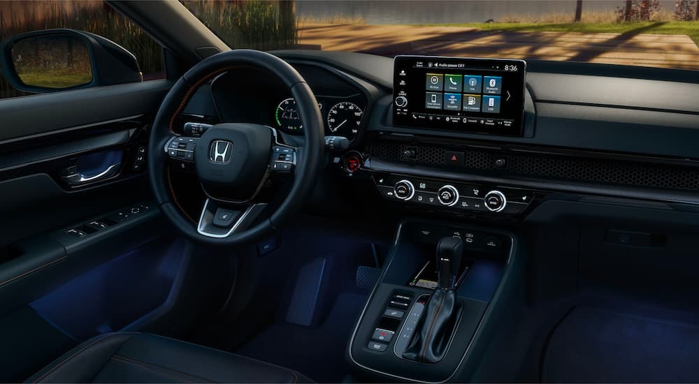The black interior and dash of a 2023 Honda CR-V is shown.