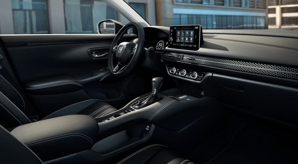 The black interior and dash of a 2023 Honda HR-V for sale is shown.