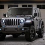 A silver 2023 Jeep Wrangler Rubicon 4xe hybrid is shown charging.