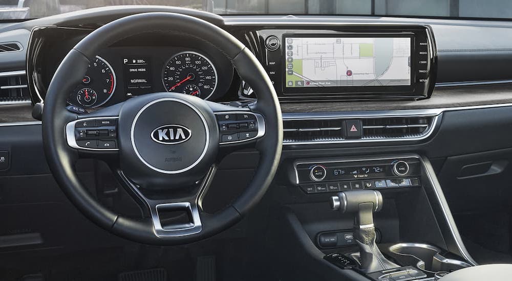 The gray interior and dash of a 2021 Kia K5 is shown.