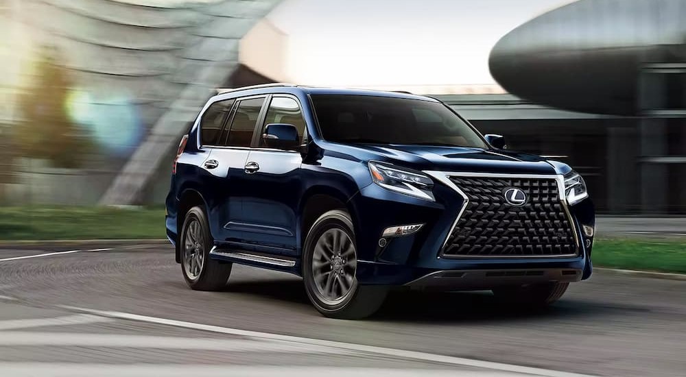 A dark blue 2023 Lexus GX is shown driving on a street.