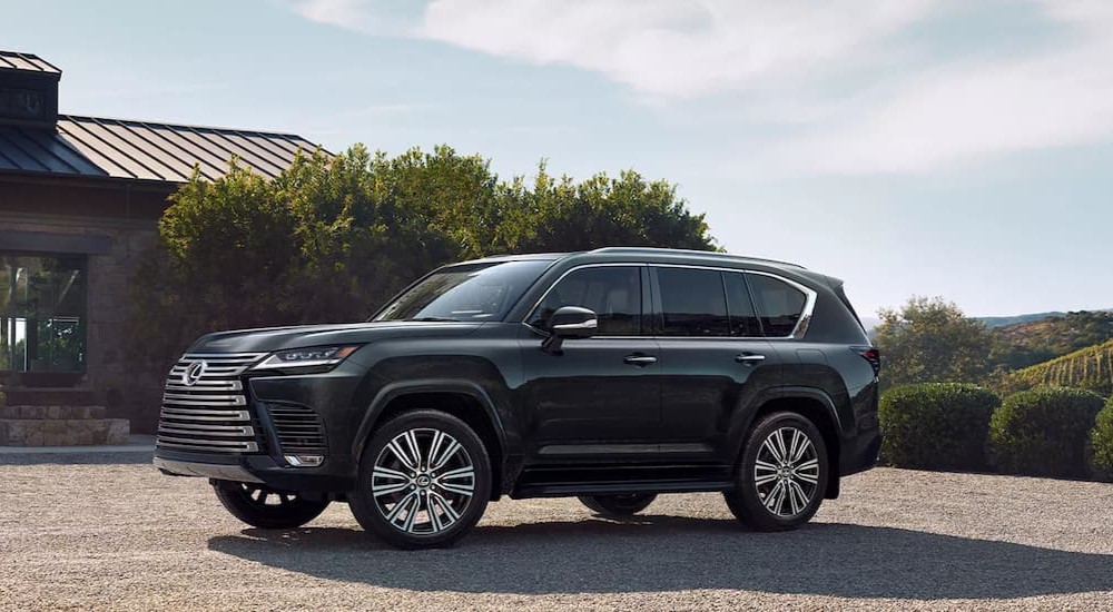 A gray 2023 Lexus LX is shown parked near a house.