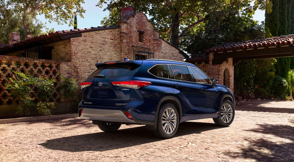 A popular Toyota Highlander Hybrid for sale, a blue 2023 Toyota Highlander Hybrid Platinum, is shown parked.