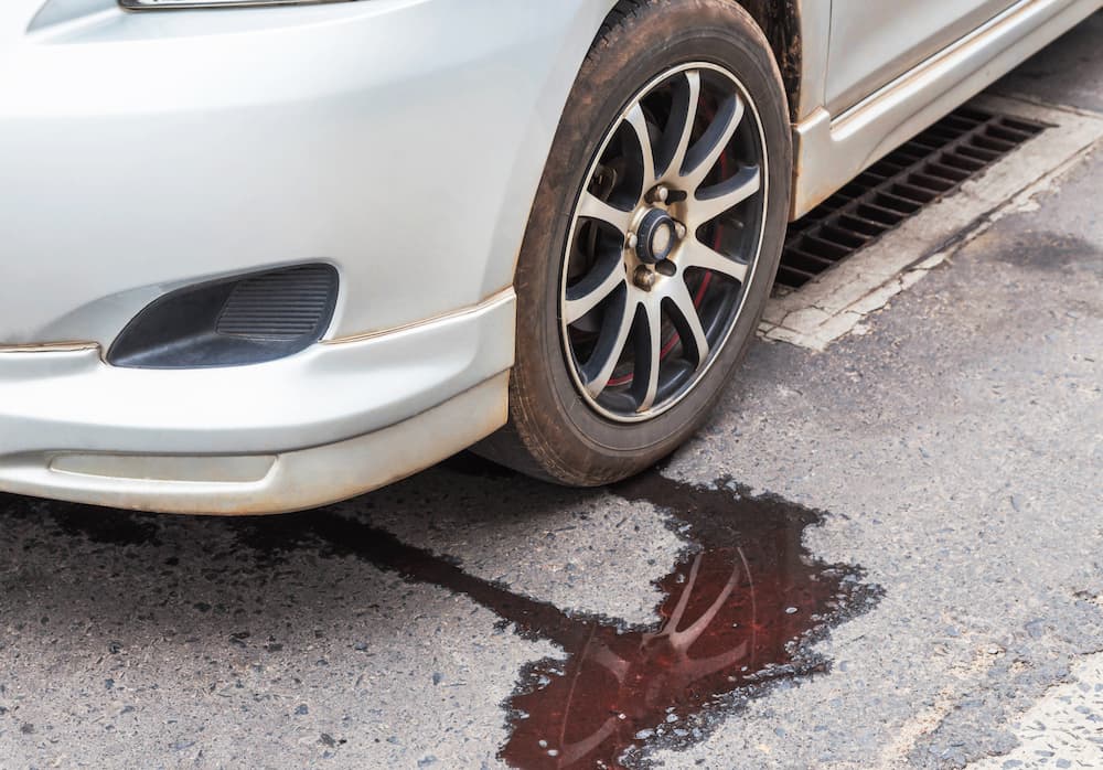 A vehicle is shown leaking fluid.