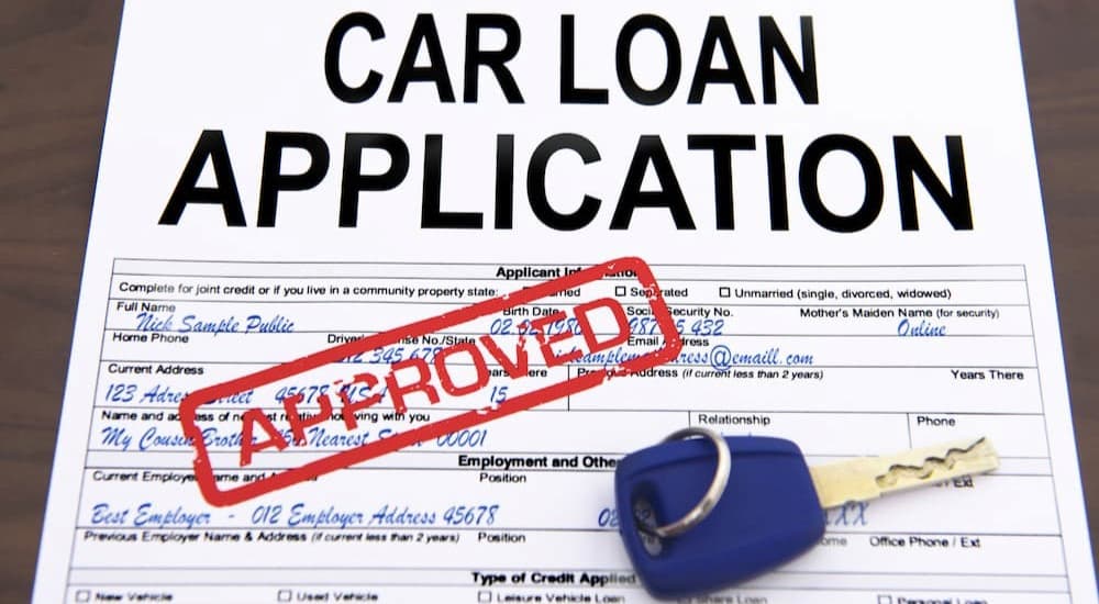 An approved stamp is shown on a car loan application.