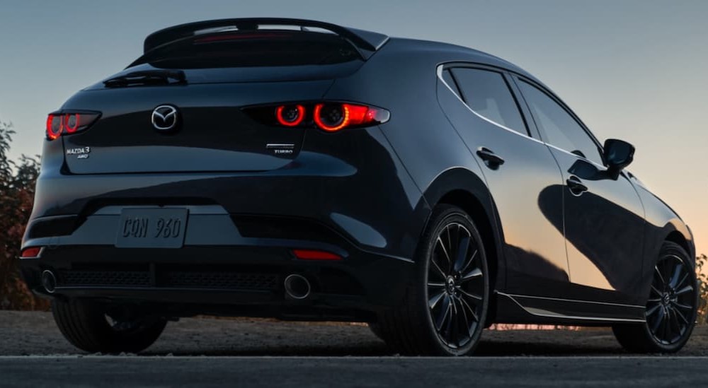 A black 2021 Mazda 3 Hatchback is shown from the rear.