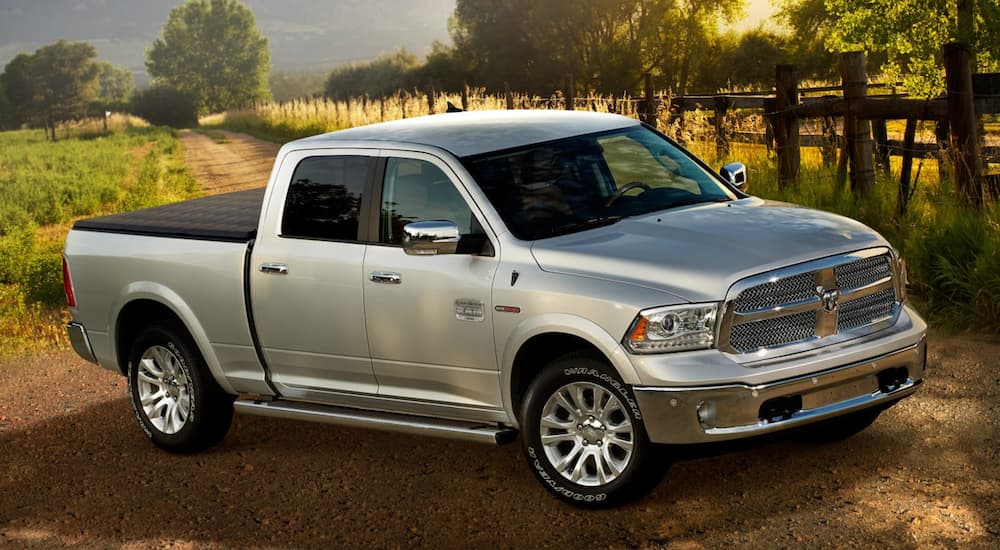 A silver 2017 Dodge Ram 1500 is shown parked on a dirt road.