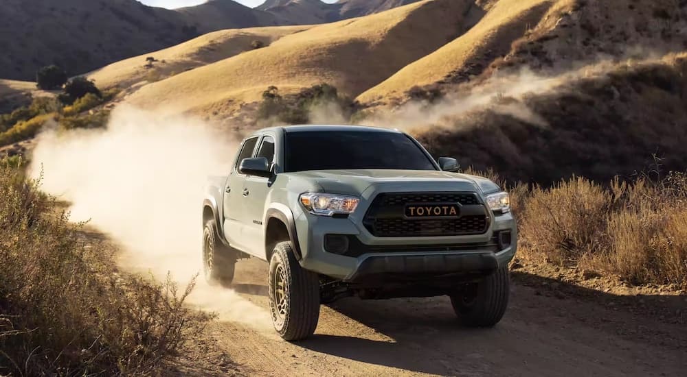 Popular used work trucks on sale, a gray 2022 Toyota Tacoma, is shown off-roading.