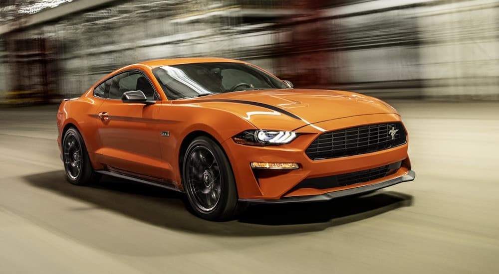 An orange 2021 Ford Mustang EcoBoost HPP is shown from the front at an angle.