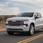 A white 2024 Chevy Silverado 1500 is shown from the front at an angle.