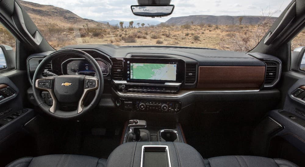 The black interior of a 2022 Chevy Silverado High Country is shown from above the center console.