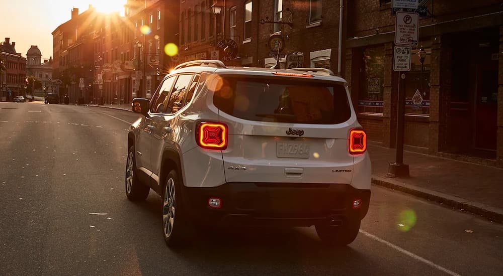 A white 2022 Jeep Renegade is shown from the rear on a city street.