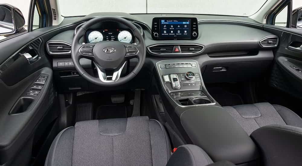 The grey interior of a 2022 Hyundai Santa Fe is shown from the driver's seat.