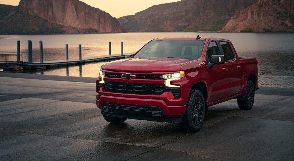 A red 2023 Chevy Silverado 1500 Z71 is parked near a dock at a lake.