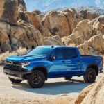 A blue 2023 Chevy Silverado ZR2 is shown parked near rocks after winning a 2023 Chevy Silverado 1500 vs 2023 Ford F-150 showdown.