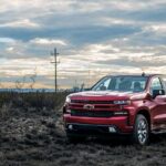 A red 2023 Chevy Silverado 1500 is shown parked off-road after winning a 2023 Chevy Silverado 1500 vs 2023 Ram 1500 comparison.