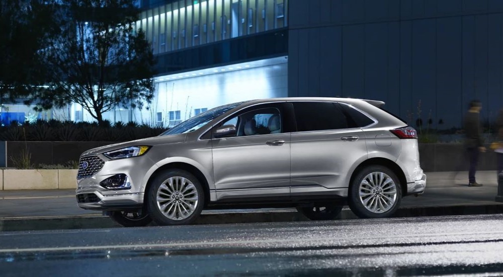 A silver 2023 Ford Edge is shown parked near a building.