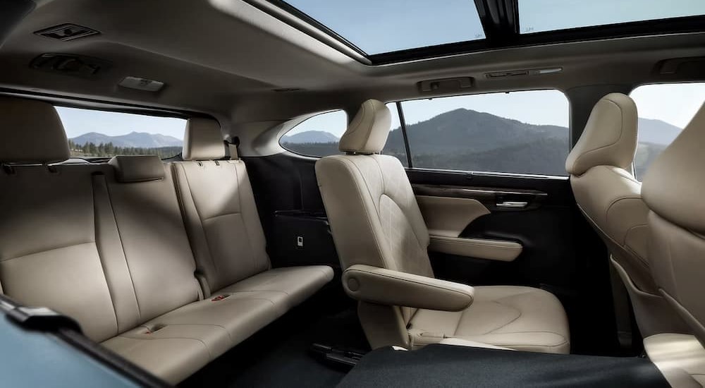 The tan and black interior of a 2023 Toyota Highlander is shown.