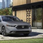 A gray 2023 Honda Accord is shown parked near a coffee shop.