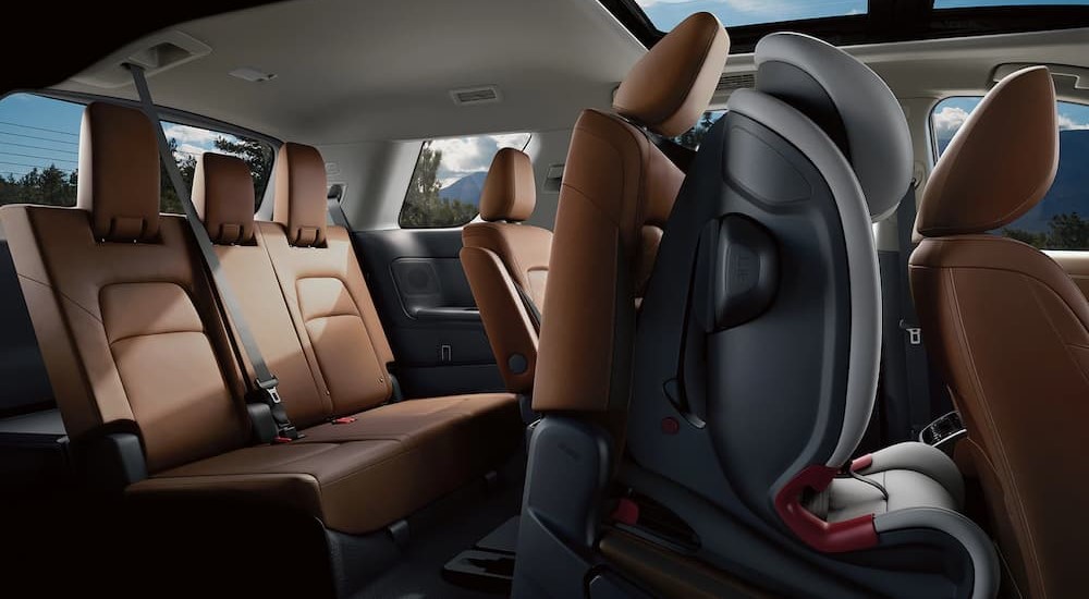 The tan and black interior of a 2023 Nissan Pathfinder is shown.